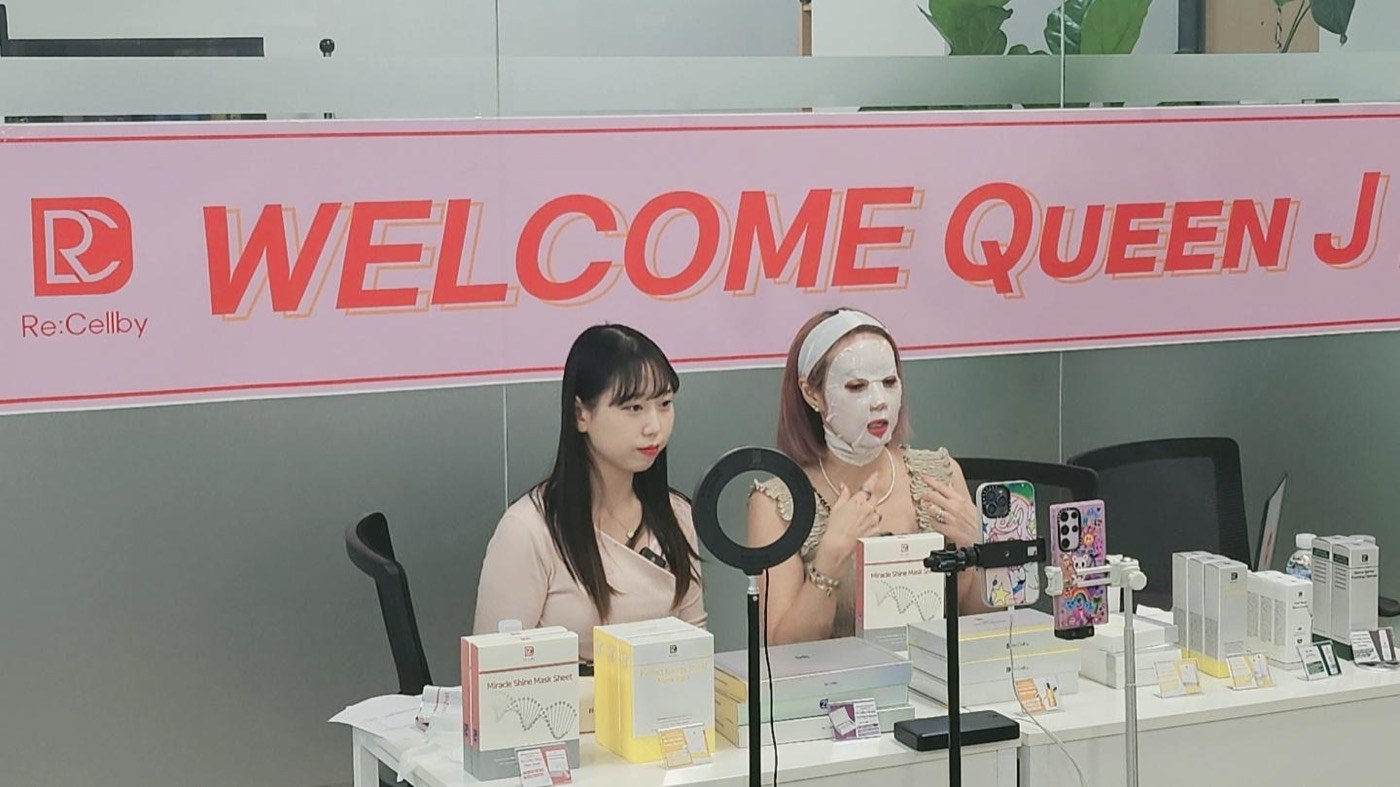 Presenters demonstrating skincare products at a livestream table