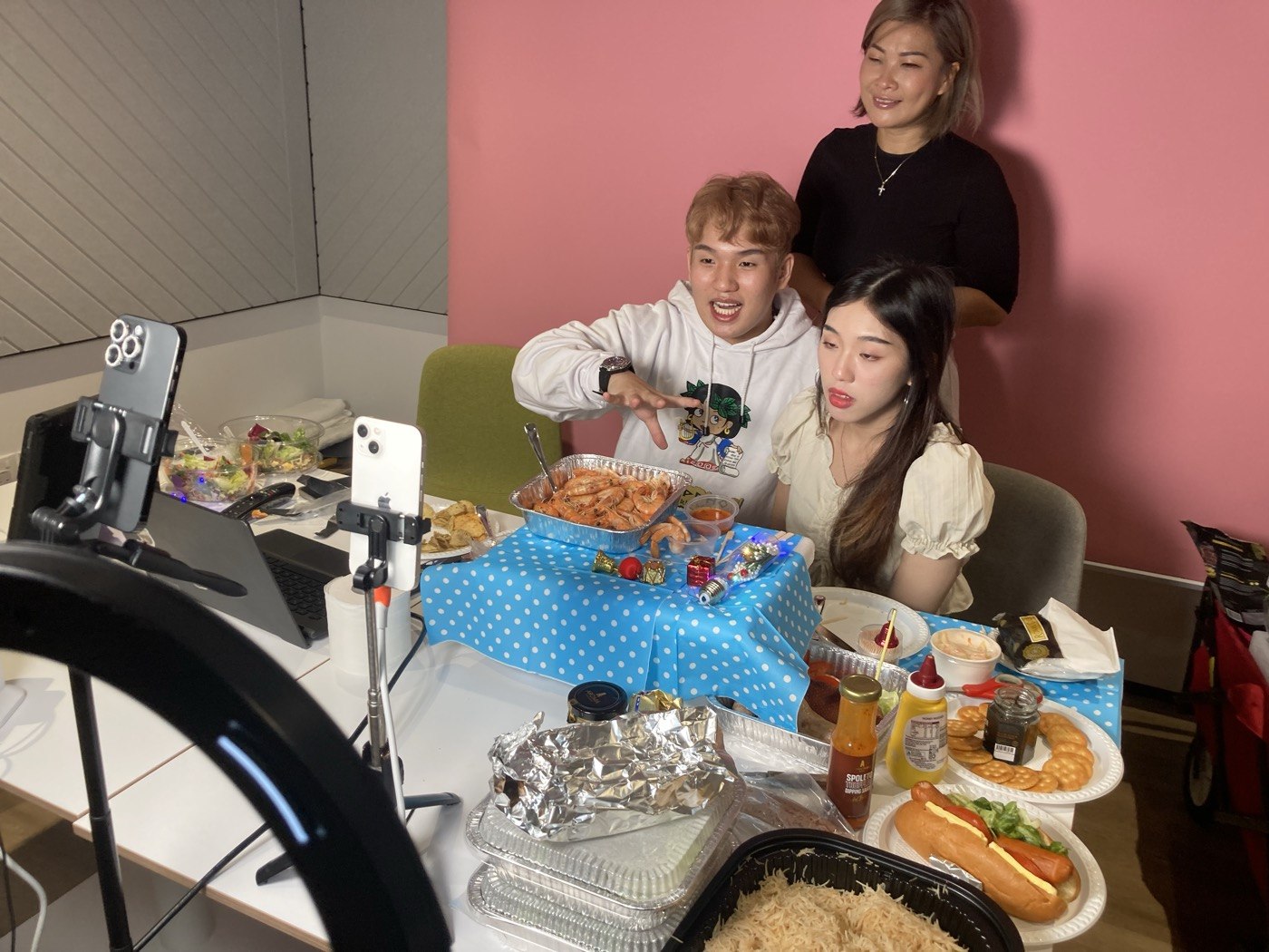 Presenters and phone cameras during a food livestream