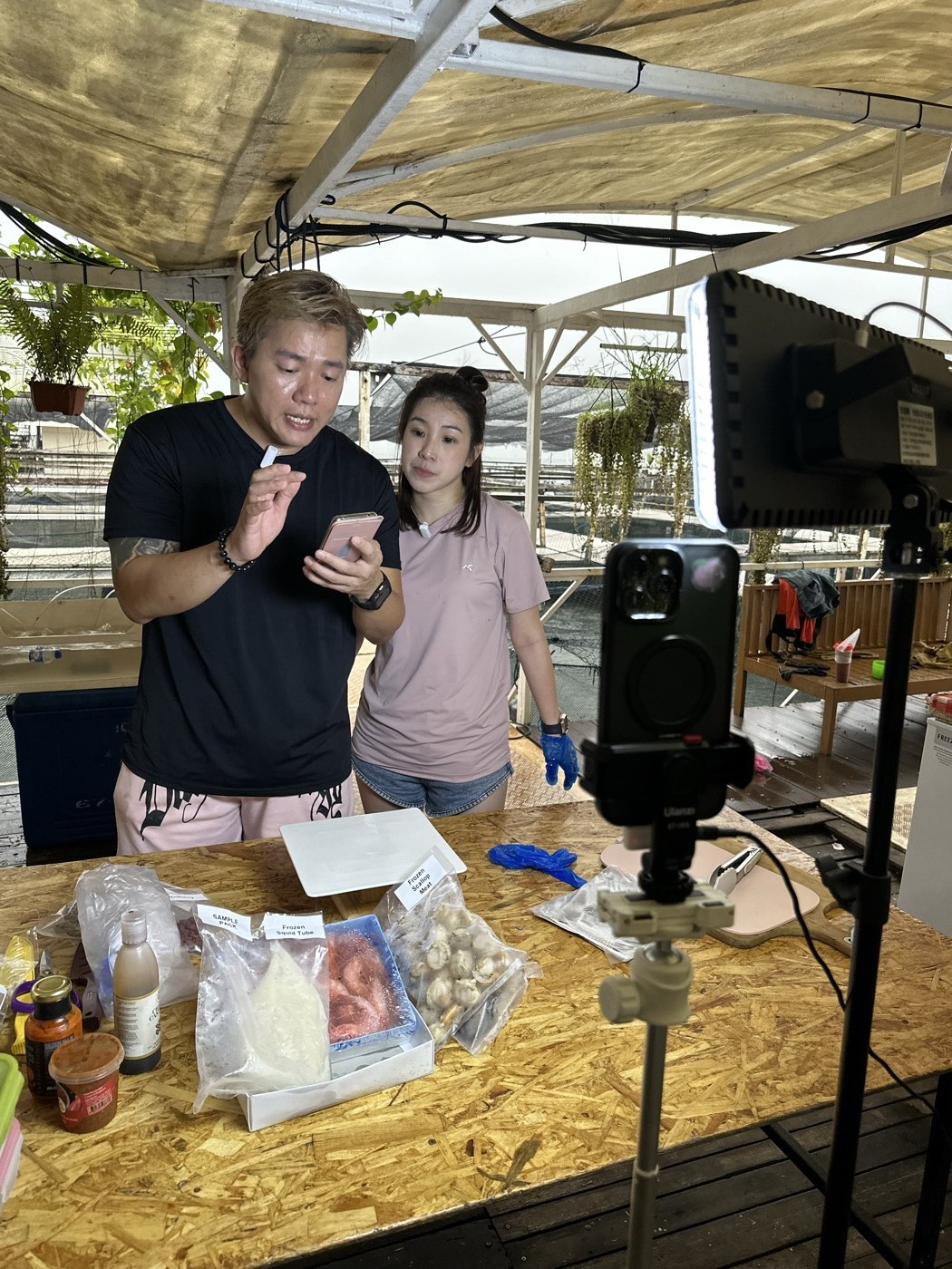 Presenters demonstrating packaged products to a livestream camera