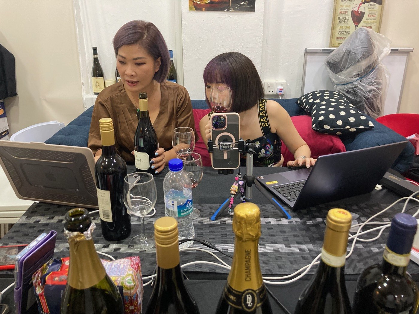 Presenters preparing product information and equipment at a livestream table